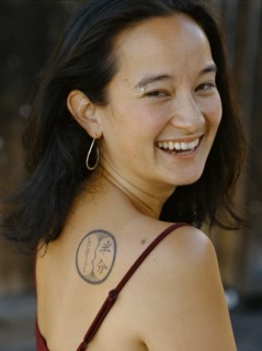 Smiling mixed race woman with tattoo