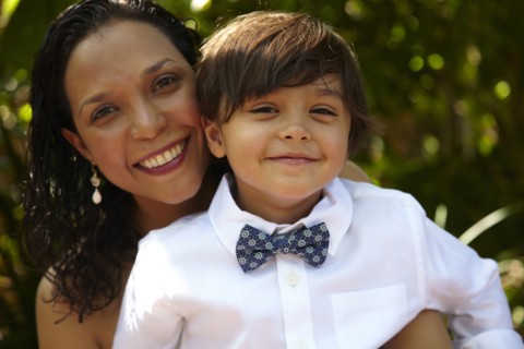 Smiling mother holding son on her lap