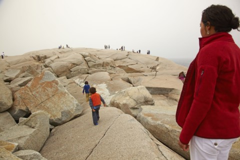 Mother and sons walking on rocks
