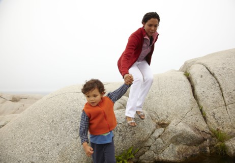 Mother and son climbing on rocks