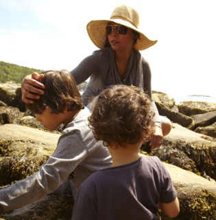Mother and sons sitting on rocks