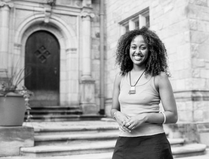 Mixed race woman smiling by church
