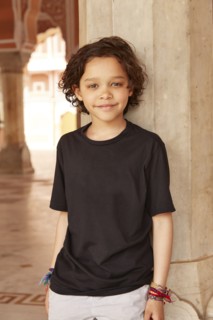 Mixed Race boy leaning on pillar