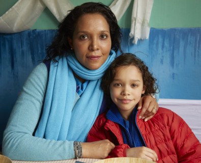Mixed Race mother hugging son