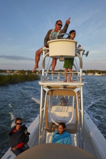 Man on boat tower pointing with son