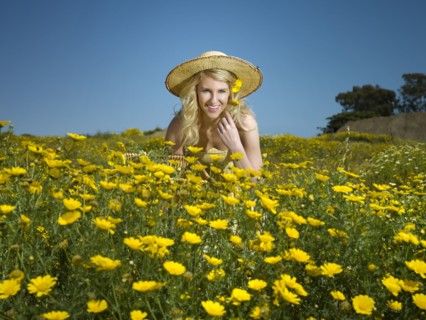 Caucasian woman picking wildflowers in field