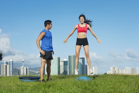 Couple exercising together in field