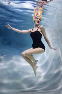 Mixed race woman swimming underwater