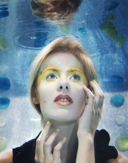 Caucasian woman with makeup on under water