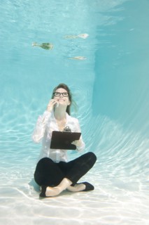 Caucasian businesswoman sitting underwater