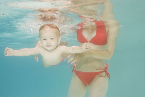 Caucasian baby swimming underwater
