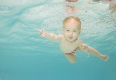 Caucasian baby swimming underwater