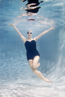 Caucasian woman swimming underwater