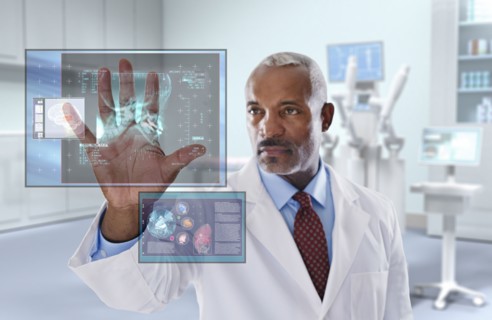 Black doctor looking at digital display in doctor's office
