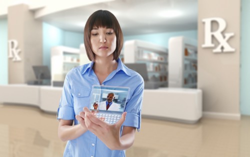 Mixed race woman using digital tablet in pharmacy