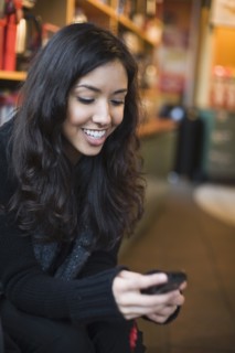 Middle Eastern woman looking at cell phone