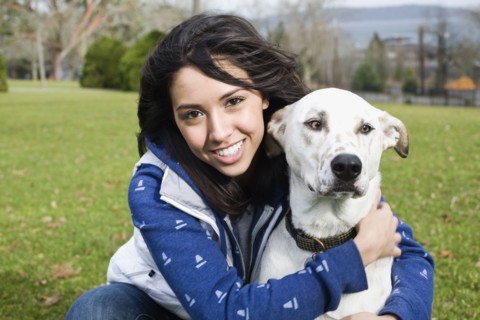 Middle Eastern woman hugging dog