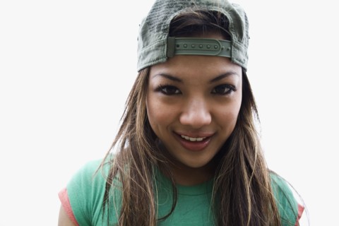Asian woman posing in backwards cap