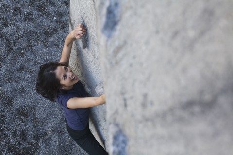 Filipino woman rock climbing
