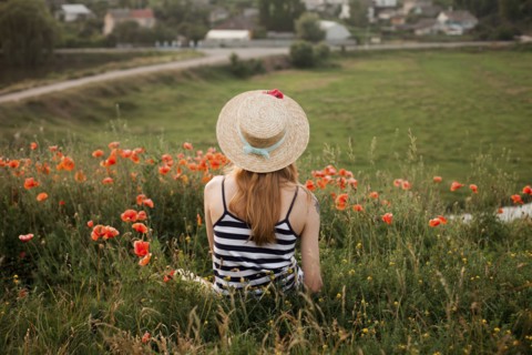 Caucasian woman sitting in wildflowers