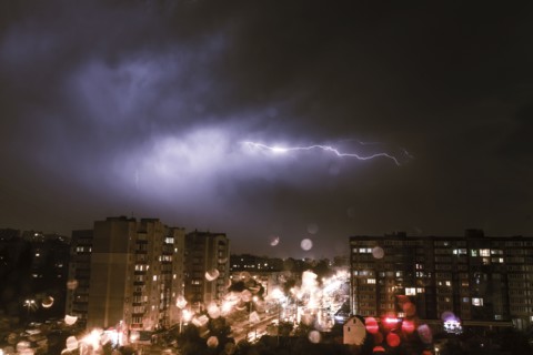Lightning striking city at night