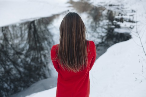 Rear view of Caucasian woman with long hair in snow
