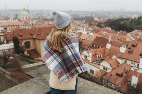 Caucasian woman admiring cityscape from rooftop