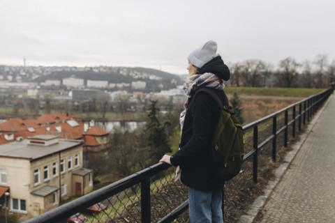 Caucasian woman wearing backpack admiring scenic view of city