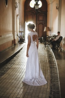 Caucasian woman wearing a wedding dress in hallway