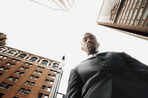 Low angle view of businessman in urban setting