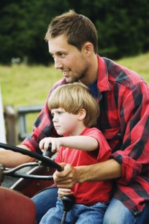 Father and on driving tractor