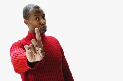 African man holding index finger up and pursing lips