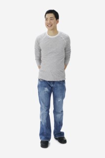Portrait of Asian man with hands behind back