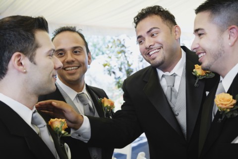 Multi-ethnic men wearing tuxedos