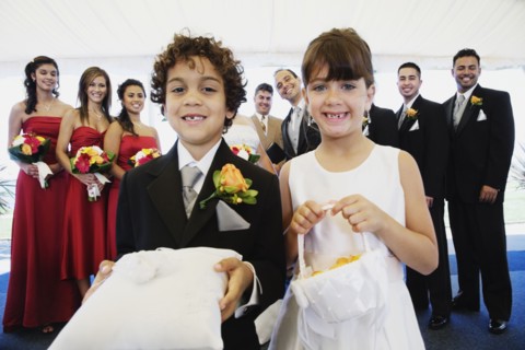 Hispanic boy and girl as ring bearer and flower girl