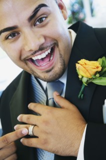 Hispanic groom showing ring