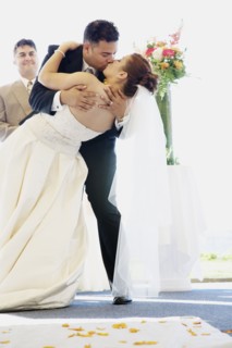 Multi-ethnic bride and groom kissing
