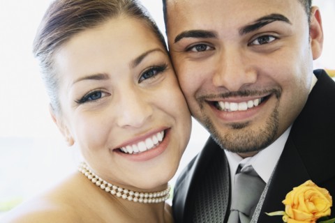 Multi-ethnic bride and groom hugging