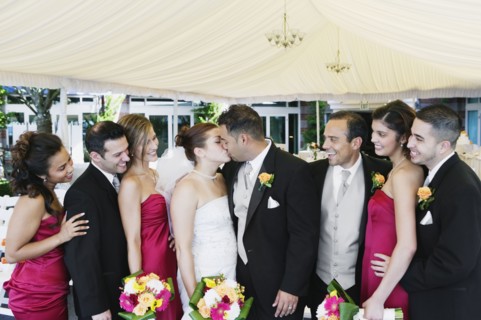 Multi-ethnic bride and groom kissing