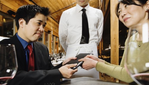 Asian couple fighting over restaurant bill
