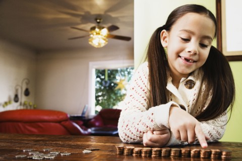 Asian girl counting coins