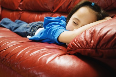 Asian girl sleeping on sofa