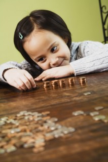 Asian girl counting coins