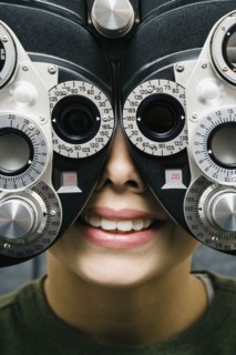 Asian boy having eyes examined