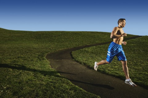 Bare chested Asian man jogging in park