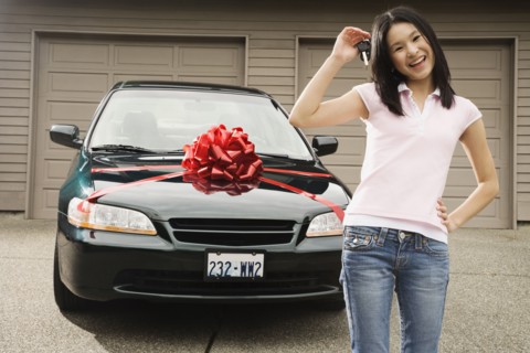 Asian teenager with keys to new car