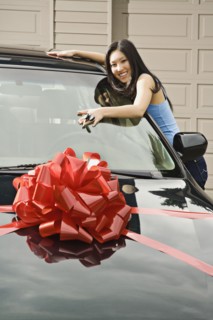 Asian teenager adoring new car