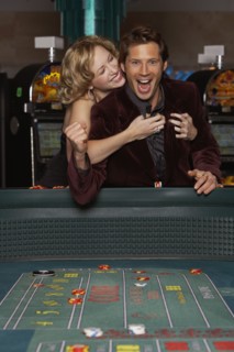 Woman hugging her successful boyfriend at a casino