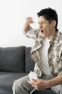 Asian man playing video games