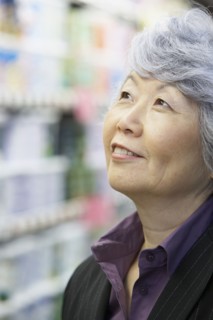 Senior Asian woman looking up